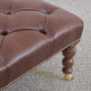 West Sussex made buttoned leather and black American walnut ottoman