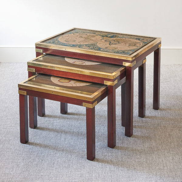 A nest of three Campaign style brass bound mahogany occasional tables, with inset map tops, c. 1980s