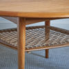 Circular teak coffee table with rattan undertier by Johannes Andersen for CFC Silkeborg, 1960s