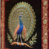 Burmese gilt-metal thread embroidered and applique panel (kalaga) depicting a peacock, c. 1900