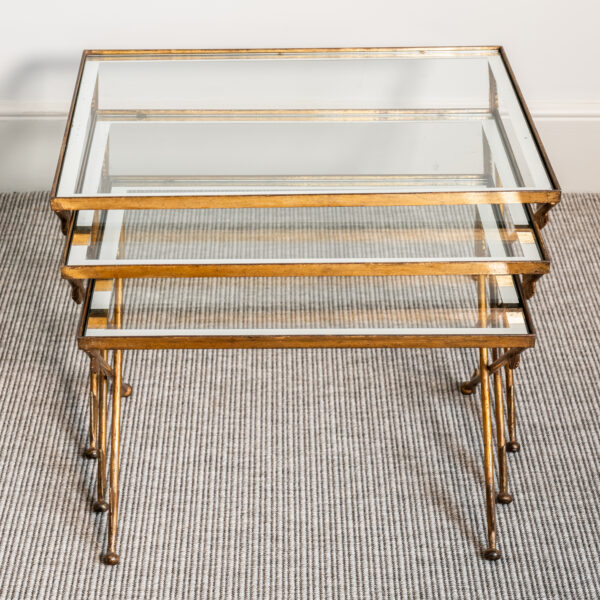 Nest of three gilt wrought iron and glass arrow side tables, c. 1930